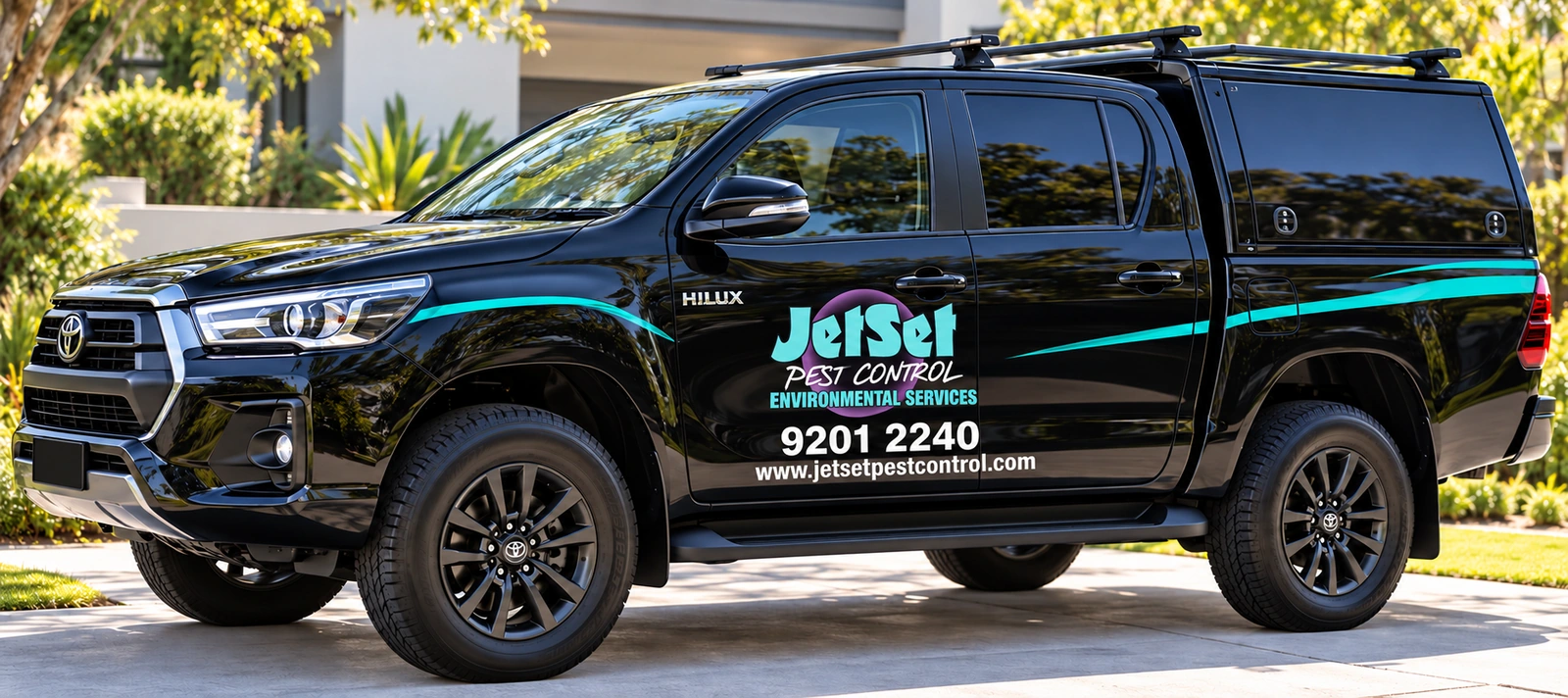 Black Jetset Hilux displaying the company logo and 9201 2240 phone number